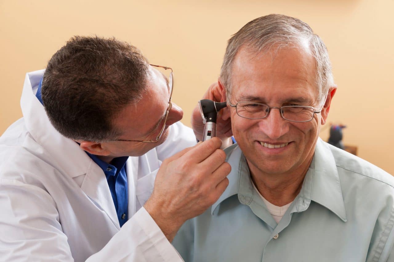 Patient being examined with an otoscope